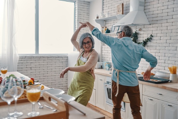 retired couple dancing in kitchen